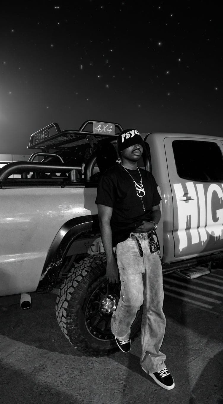Black and white shot leaning on a truck at night