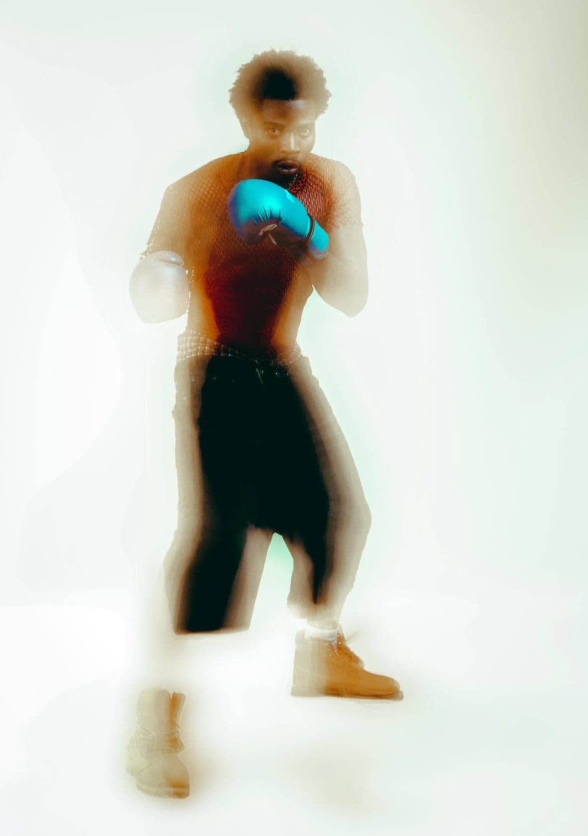 Motion-blurred boxing pose in a studio