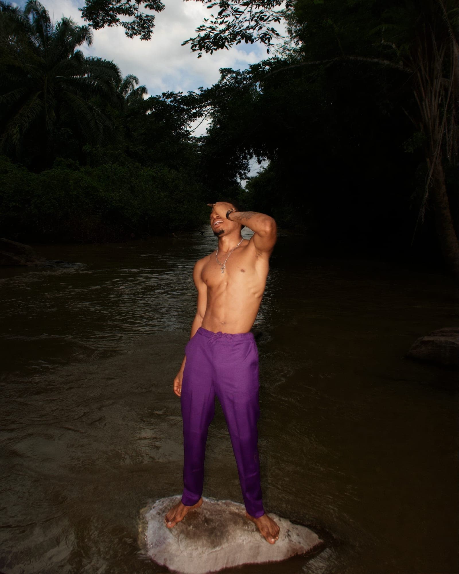 Purple trousers, standing on a rock in a river